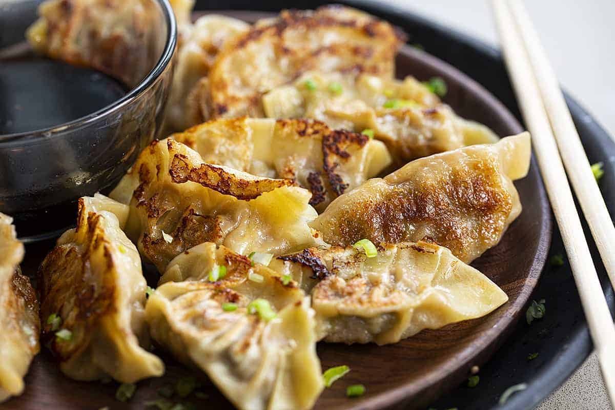 Plate of Potstickers with ChopSticks a Homemade Sauce