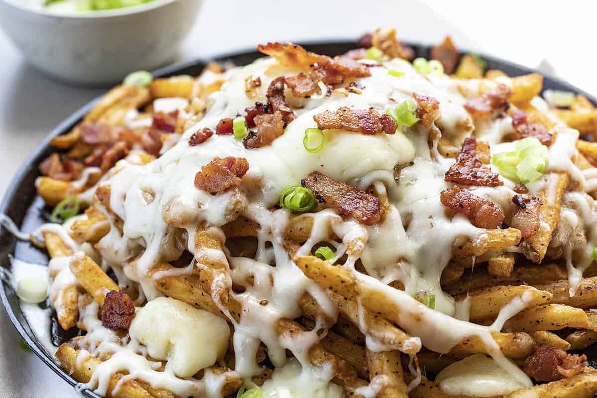 Poutine on a Flat Skillet with Melted Cheese and Scallions SPrinkled