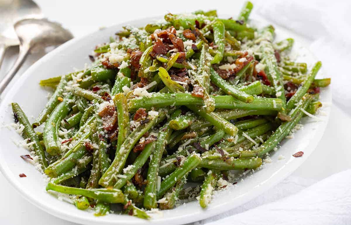 White Plate of Spicy Green Beans with Bacon and Cheese 