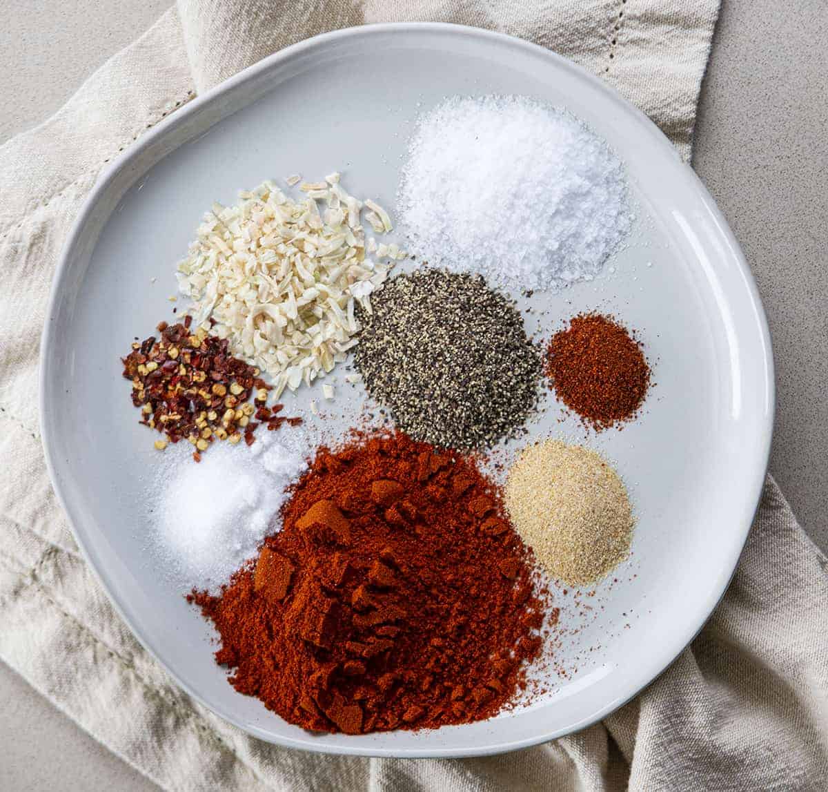 All the Ingredients for Hamburger Seasoning on a Plate