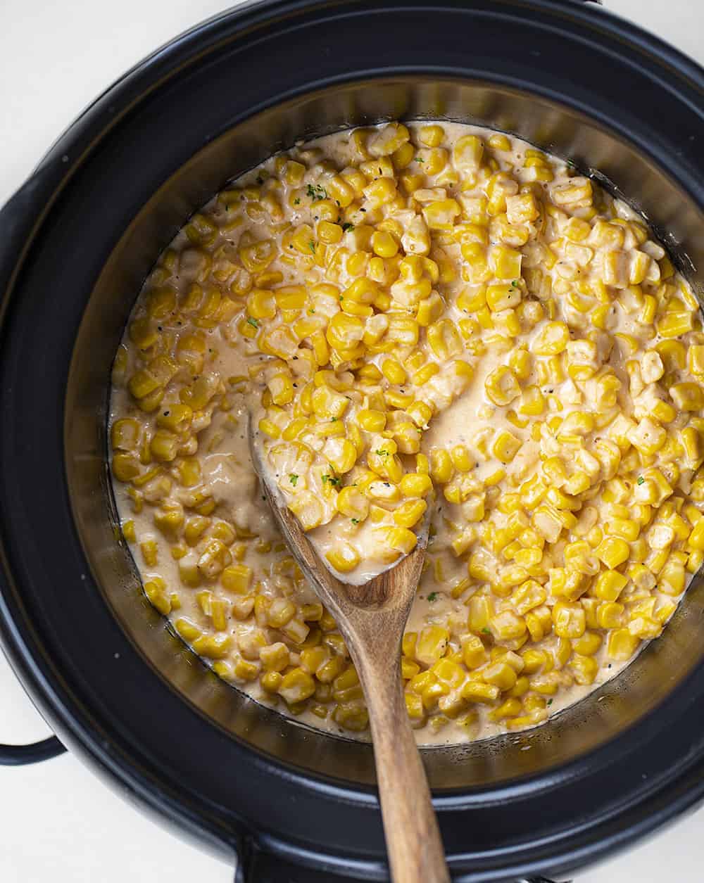 Completed Crockpot Cheesy Corn with Spoon in It