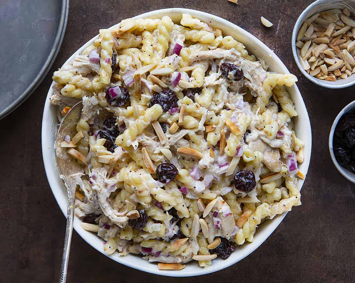 Overhead View of Cherry Chicken Salad in a Bowl with Antique Spoon and Slivered Almonds