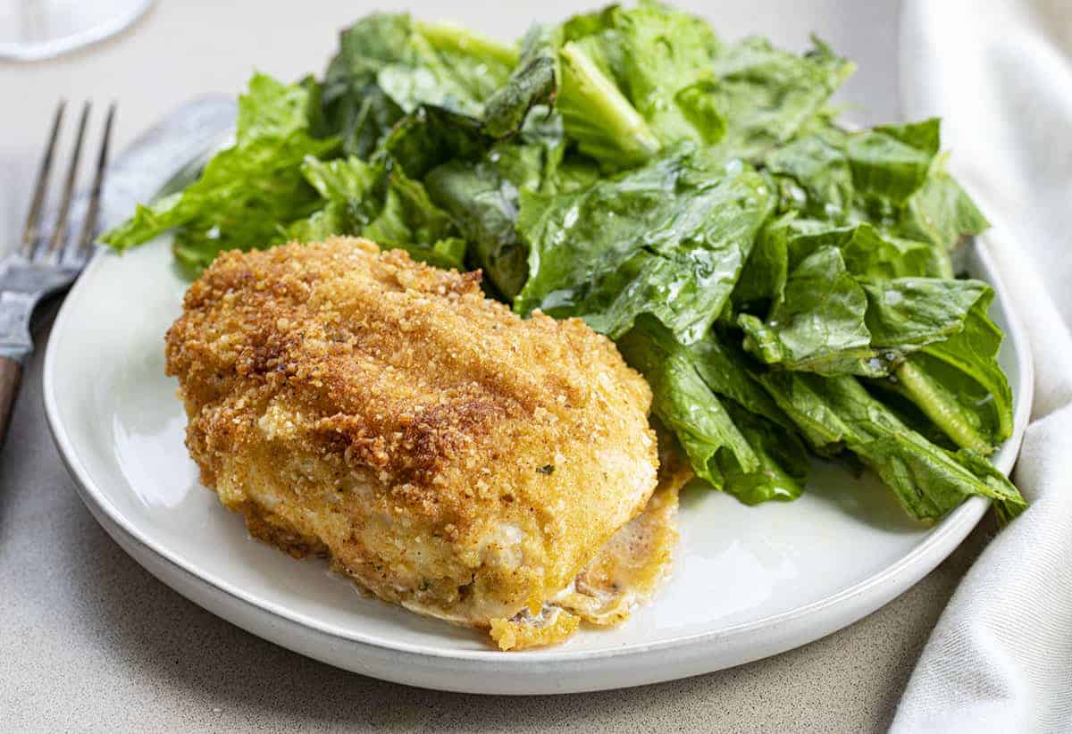 Chicken Kiev on a White Plate with Greens