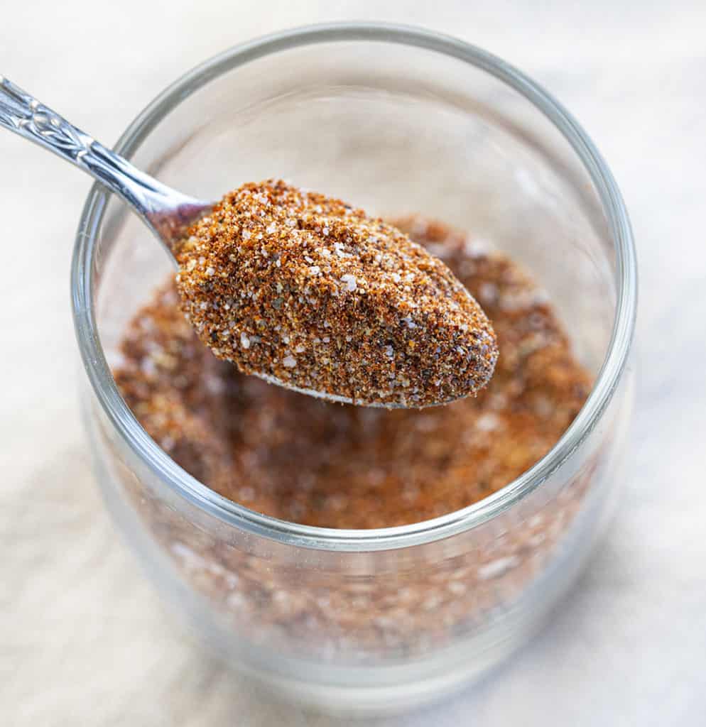 Spoonful of homemade chili seasoning in a jar Spoonful of homemade chili seasoning in a jar.
