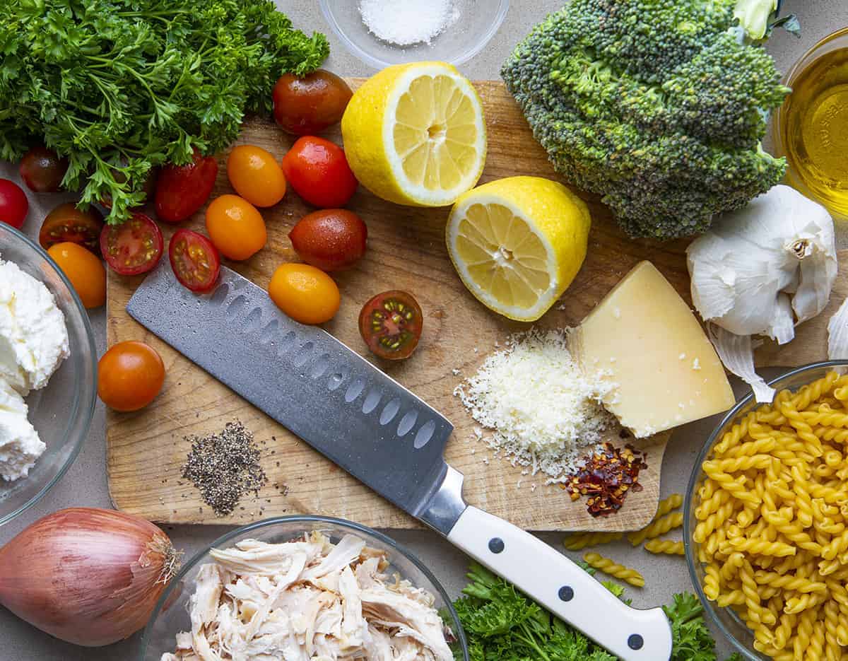 Raw Ingredients for Creamy Chicken Pasta with Roasted Vegetables on Cutting Board from Overhead