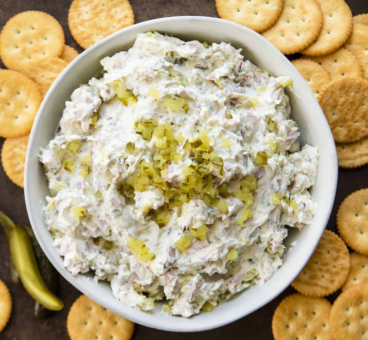 Overhead Image of Dill Pickle Dip in White Bowl with Crackers Around Base