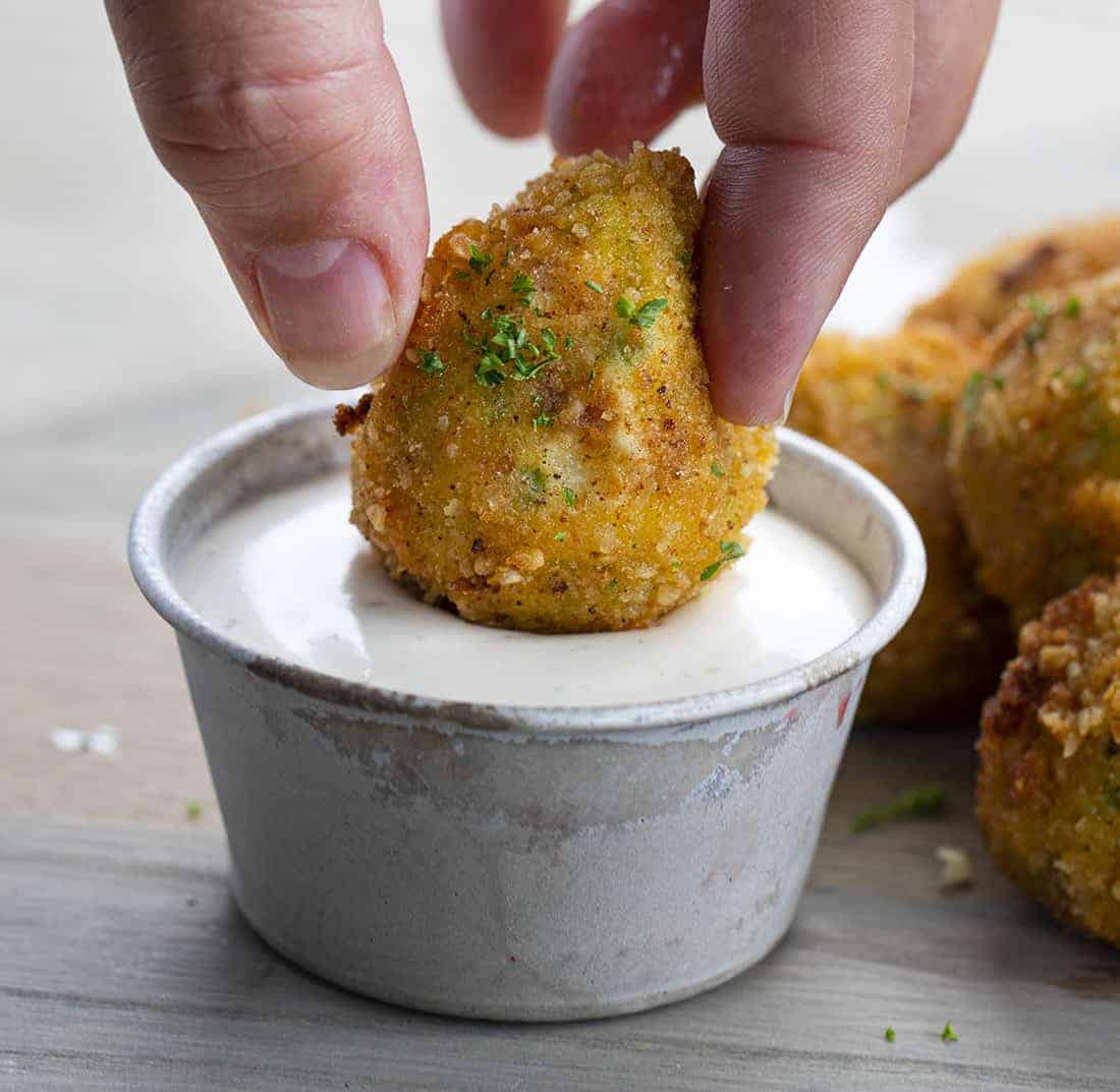 Dipping Fried Jalapeno Popper Bite into Sauce