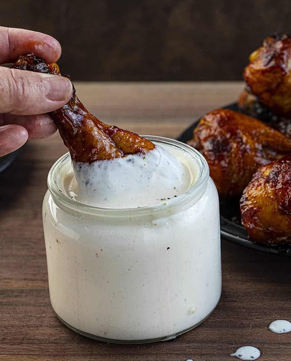 Hand Dipping Chicken Into Alabama White Sauce Recipe