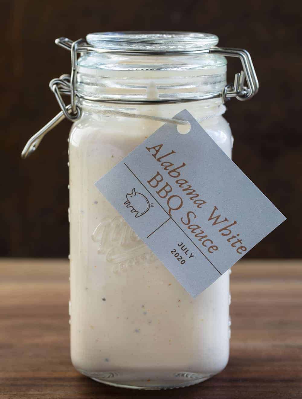 Jar of Labeled Alabama White Sauce Recipe on Cutting Board