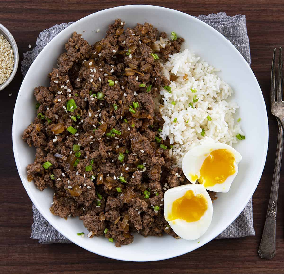 Overhead Image of Beef Bulgogi in a White Bowl with Rice and Eggs