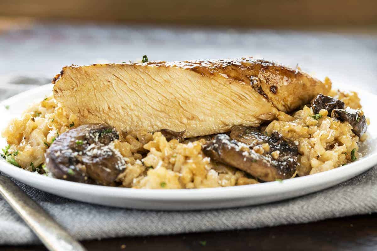 One piece of Chicken Mushroom Risotto Cut into Showing Juicy Inside of Chicken