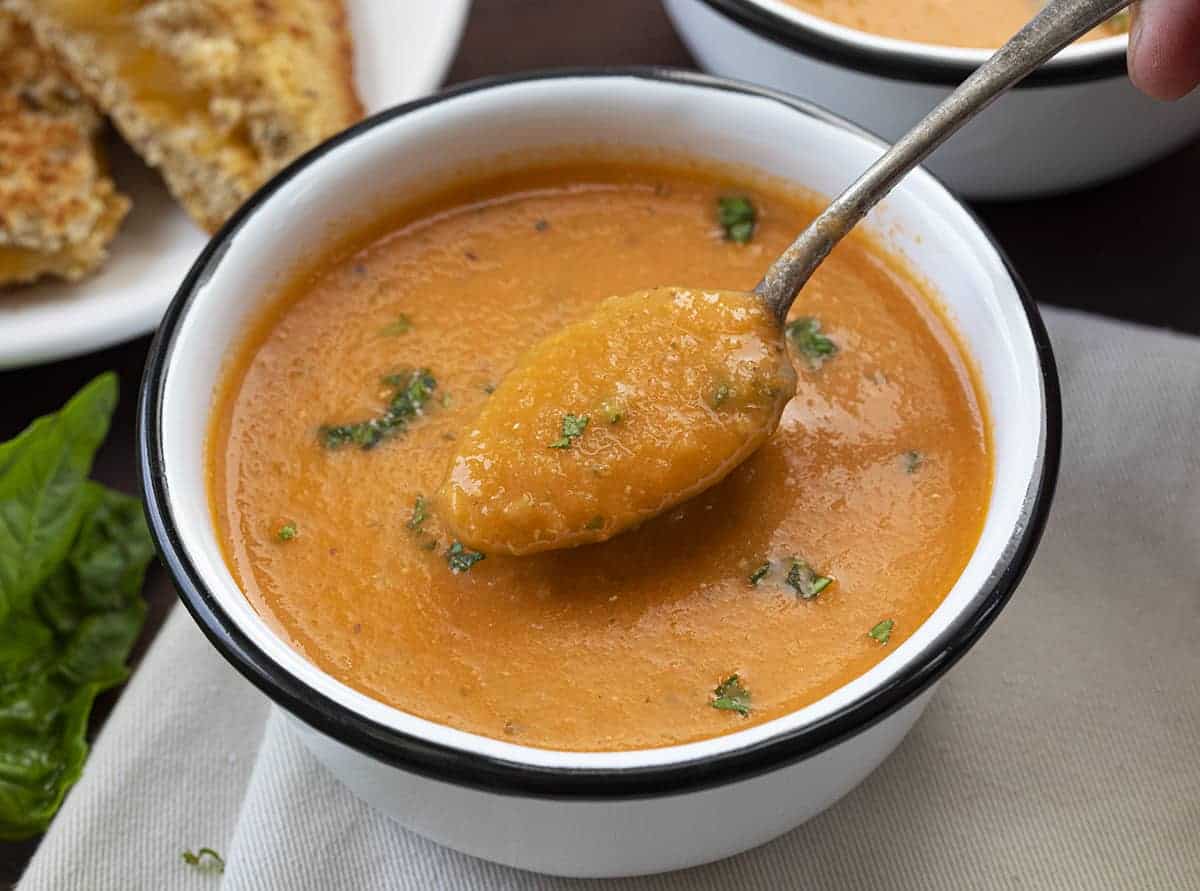 Spoon in a Bowl of Roasted Tomato Soup Recipe Showing Texture