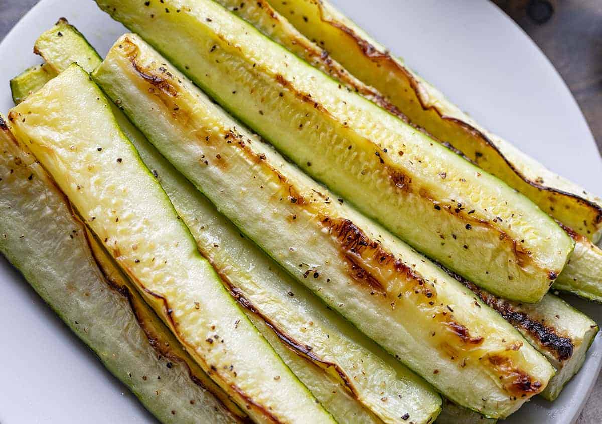 Very Close up of Roasted Zucchini Spears on White Plate