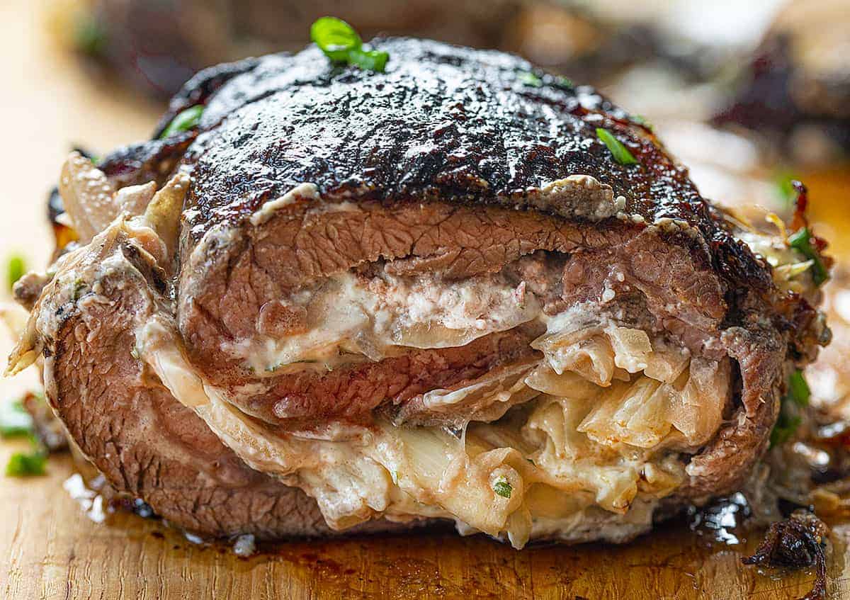 Cheesy Stuffed Flank Steak Cut Into on Cutting Board