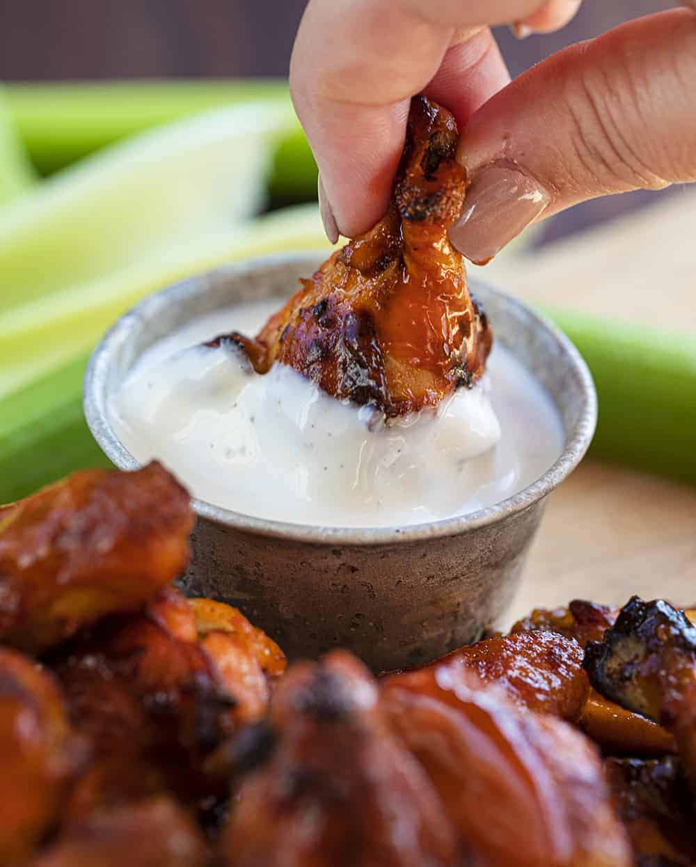 Dipping Buffalo Chicken Wings in Ranch or Bleu Cheese