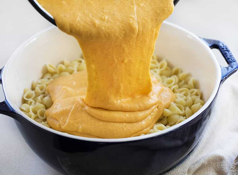 Pouring Pumpkin Cheese Mixture over Noodles