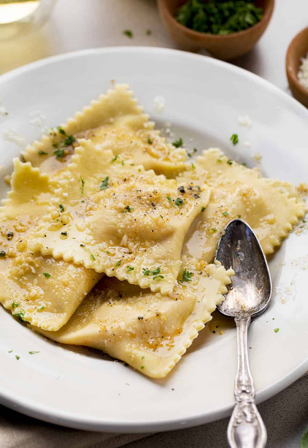 Homemade Pumpkin Ravioli with Garlic Brown Butter On Plate with Spoon