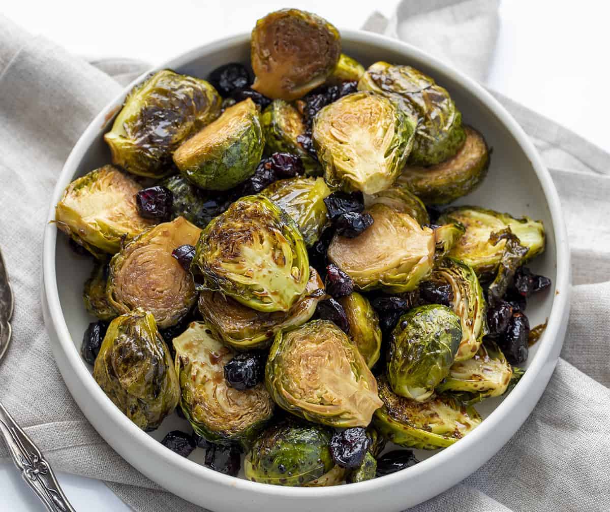Bowl of Balsamic and Cranberry Roasted Brussels Sprouts on White Surface
