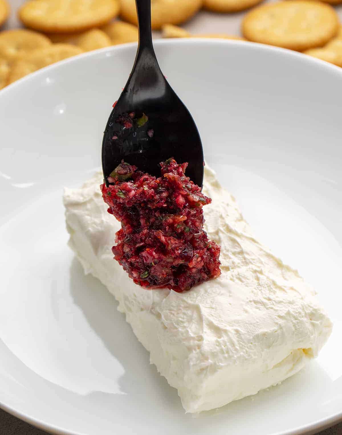 Spooning Cranberry Salsa on Cream Cheese