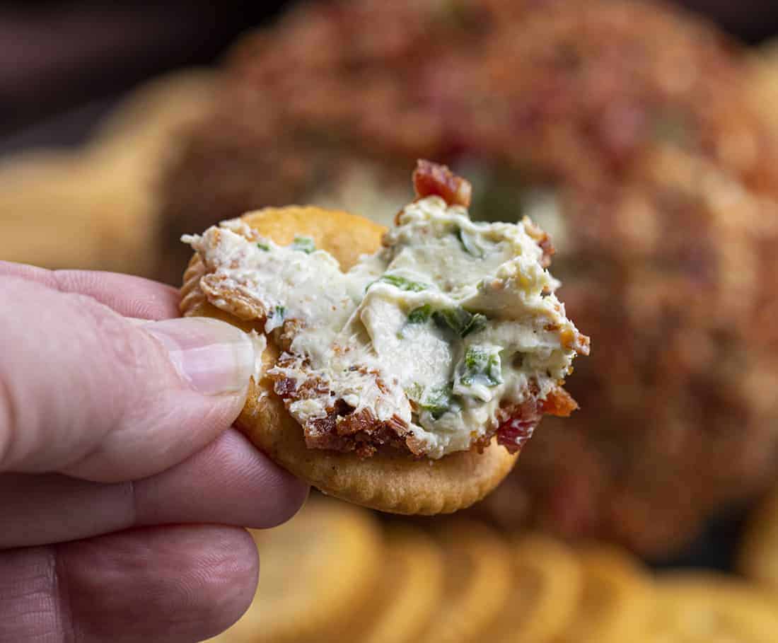 Dipping Cracker into Bacon Jalapeno Ranch Cheeseball