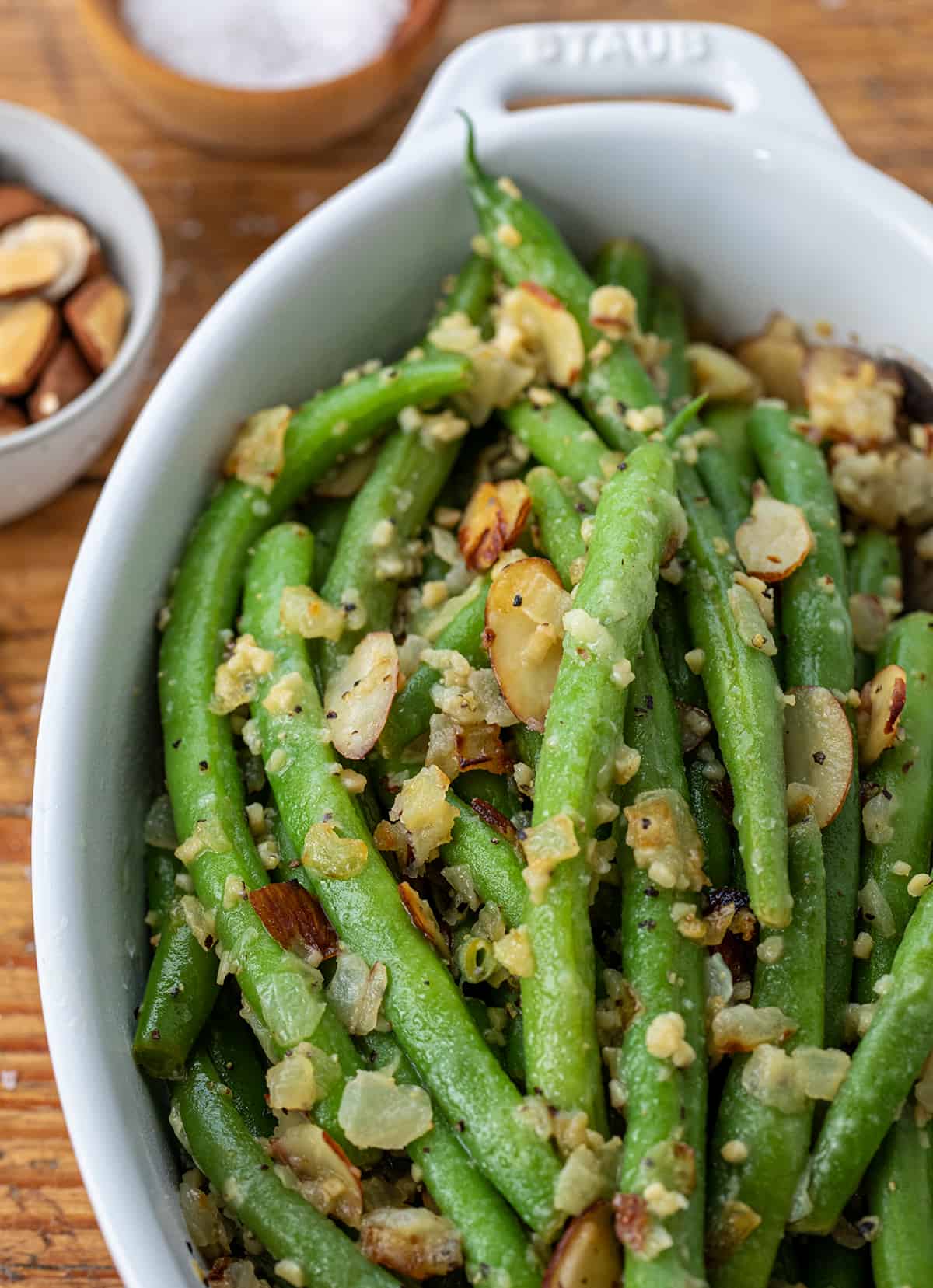 Close up of Green Beans Almondine in a White Casserole Dish.