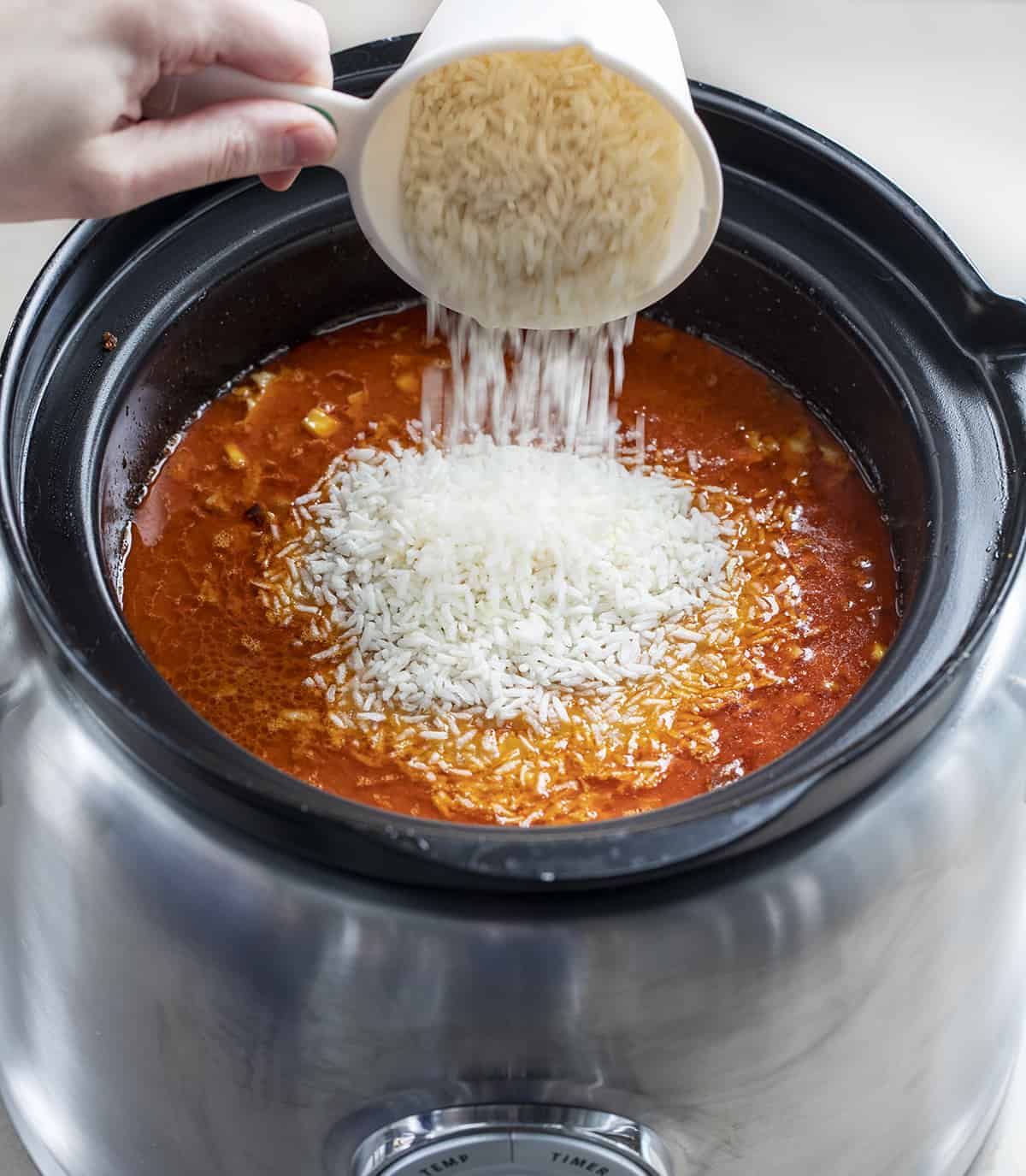 Adding Rice to a Crockpot of Spicy Chipotle Chicken Soup