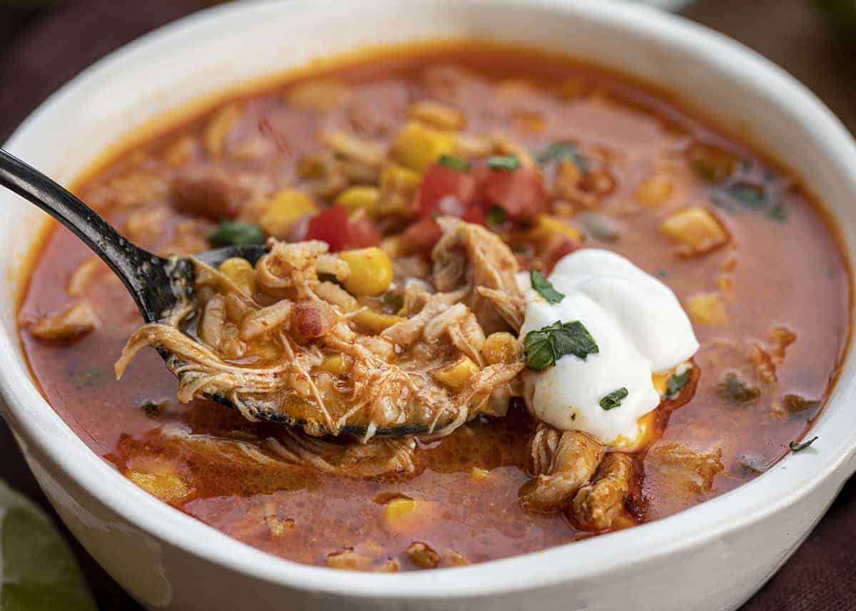 Bowl of Spicy Chipotle Chicken Soup with a Spoonful