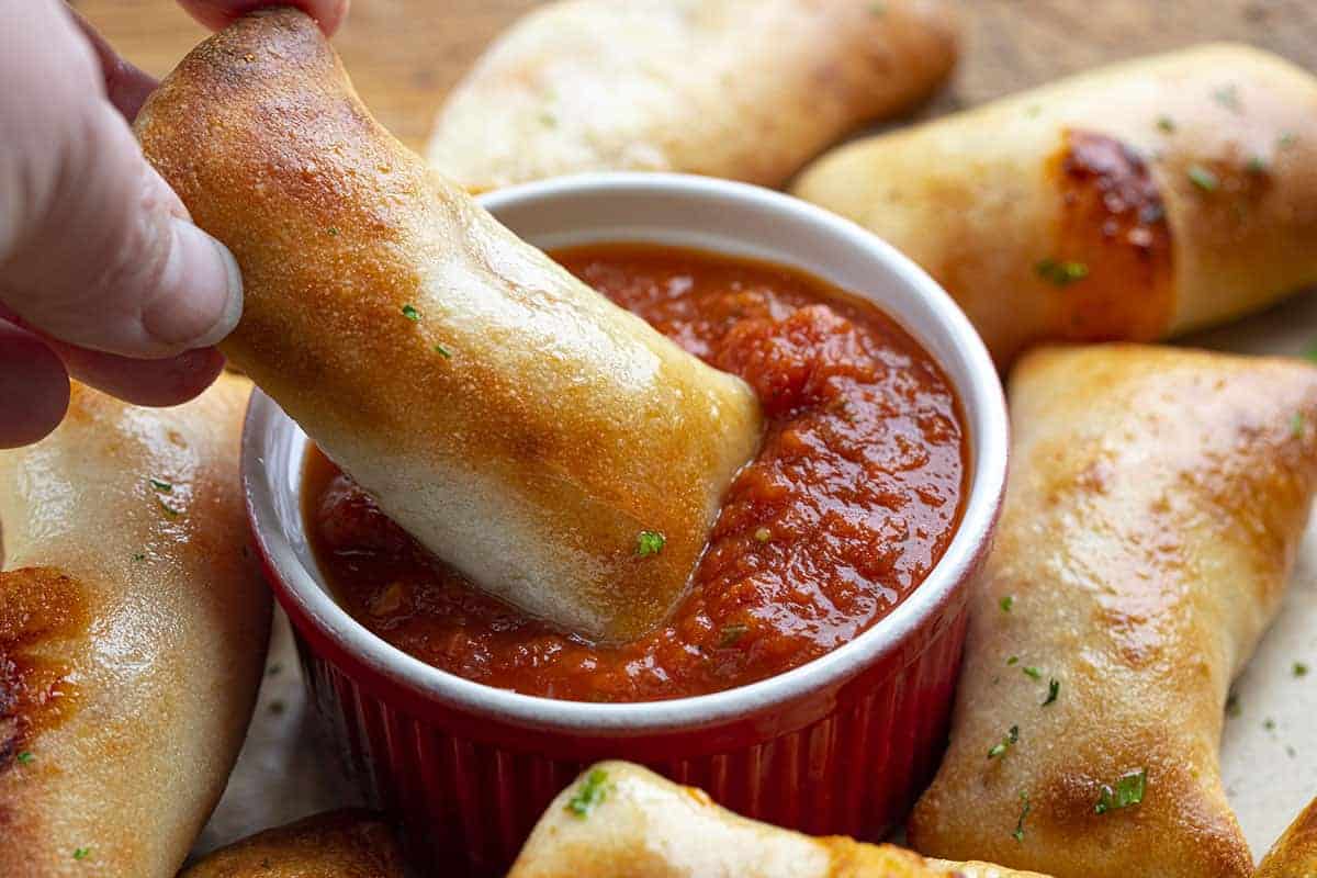 Dipping Air Fryer Pizza Roll into Sauce
