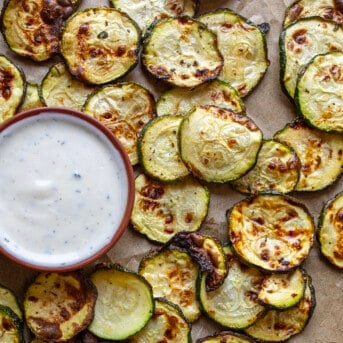 Overhead Image of Ranch Zucchini Chips Next to Ranch Dressing.