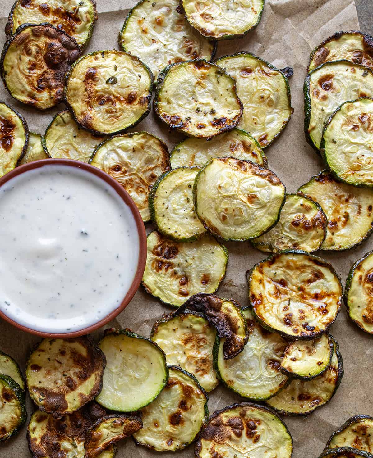 Overhead Image of Ranch Zucchini Chips Next to Ranch Dressing. 
