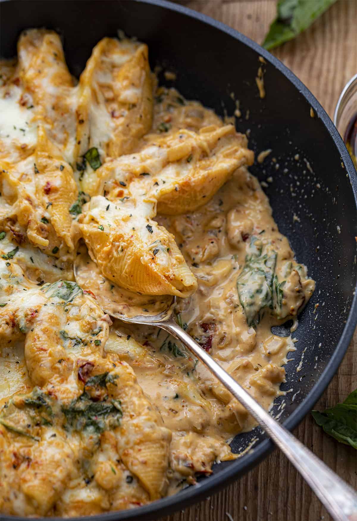 Skillet of Tuscan Stuffed Shells with Spoon