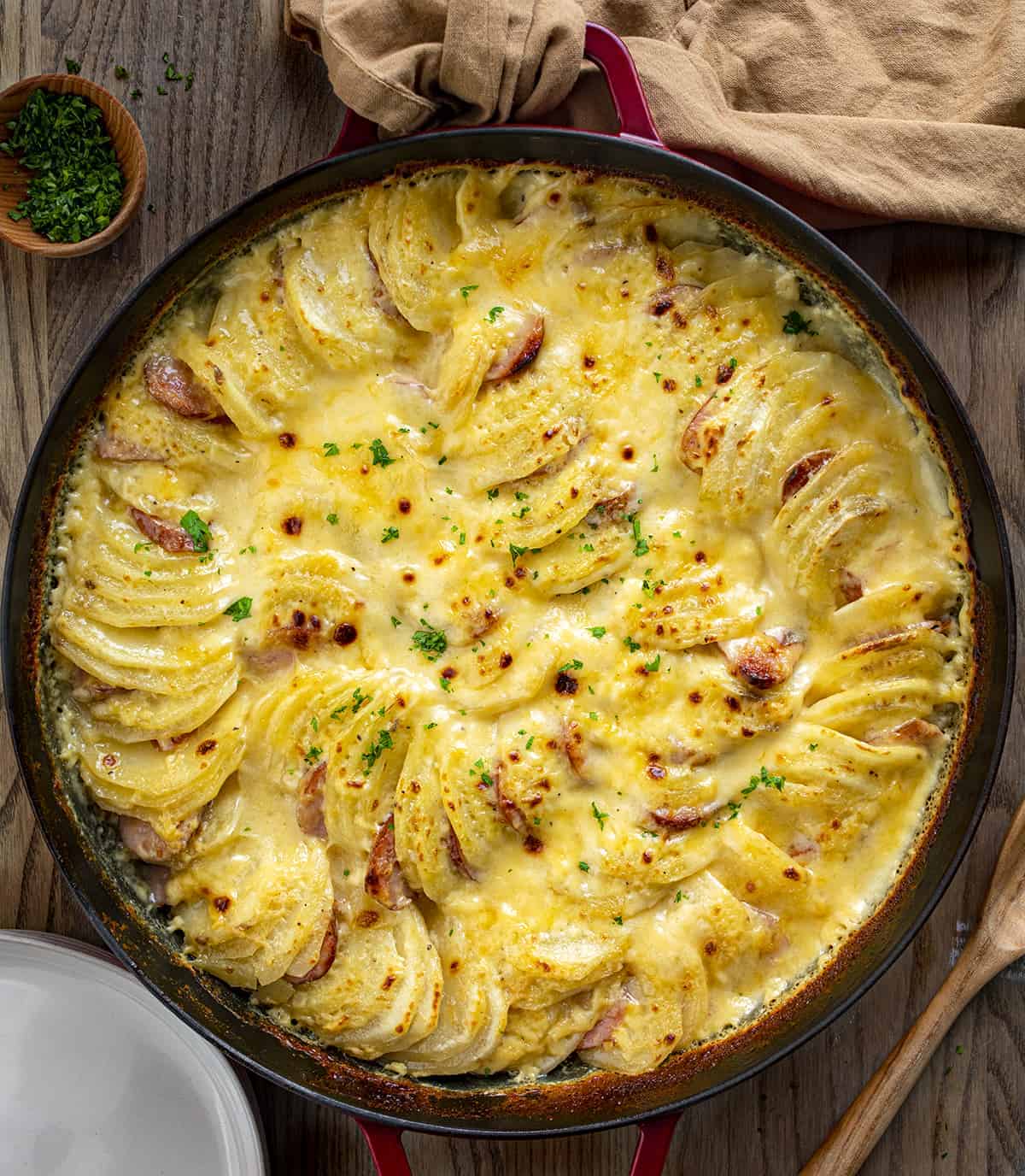 Overhead of Potatoes Au Gratin with Smoked Sausage in Pan