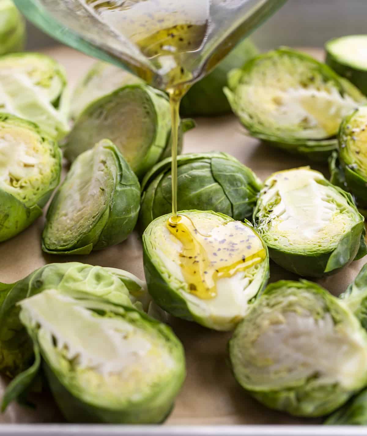 Drizzling Brussels Sprouts on Pan