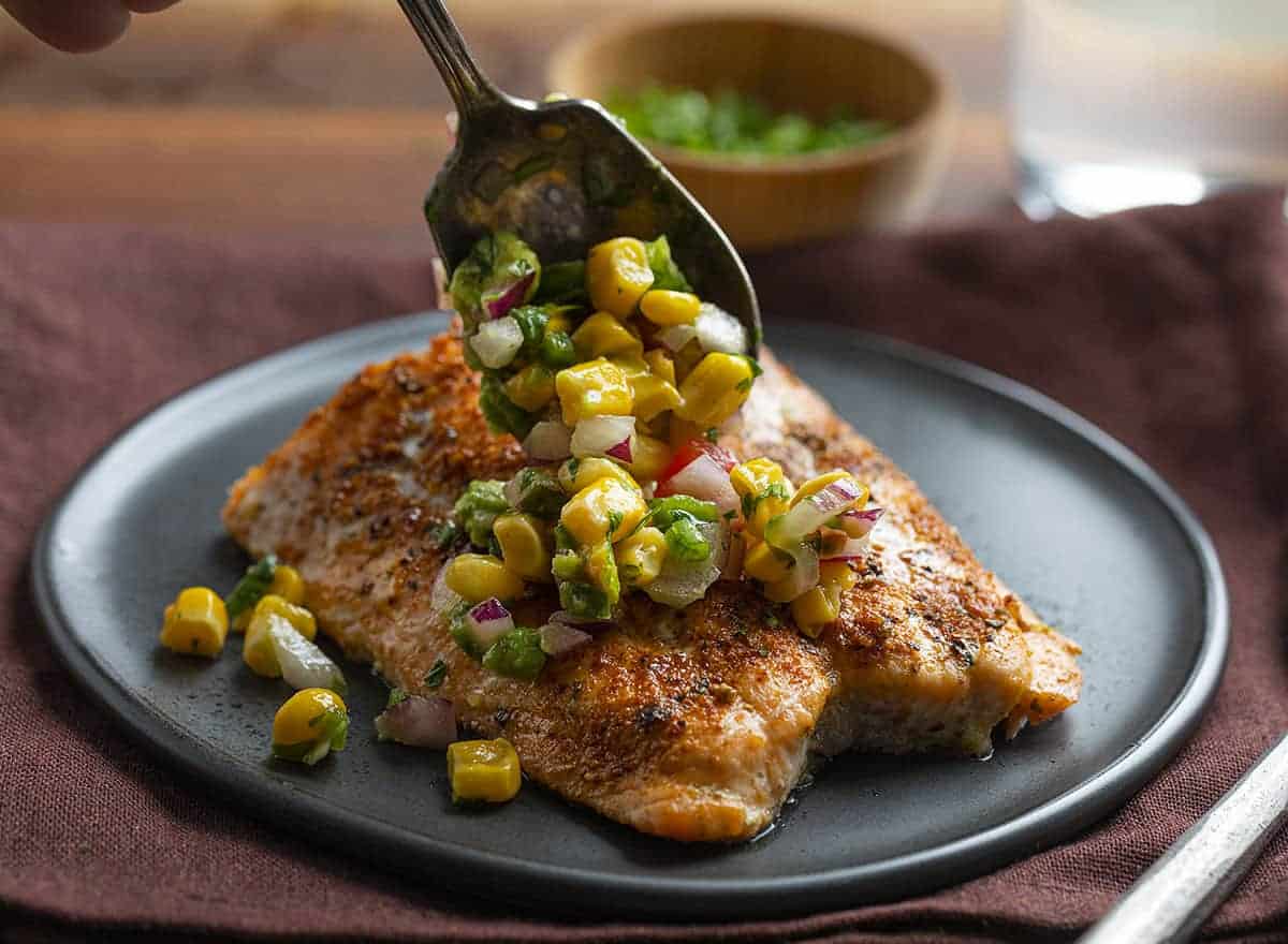 Adding Avocado Corn Salsa to Blackened Salmon