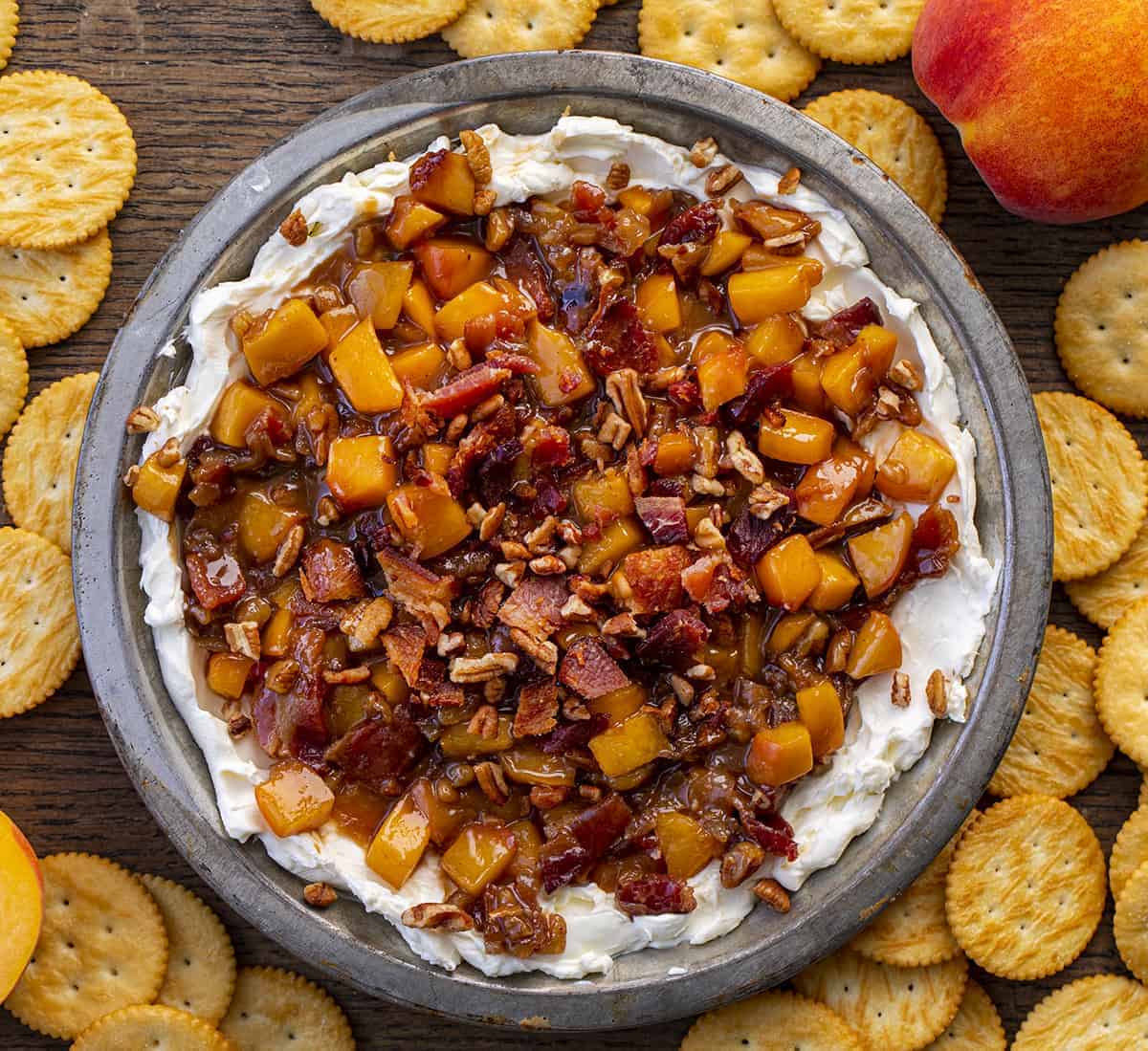 Overhead of Bourbon Peach Pecan Dip in a Pan with Ritz Crackers around it.