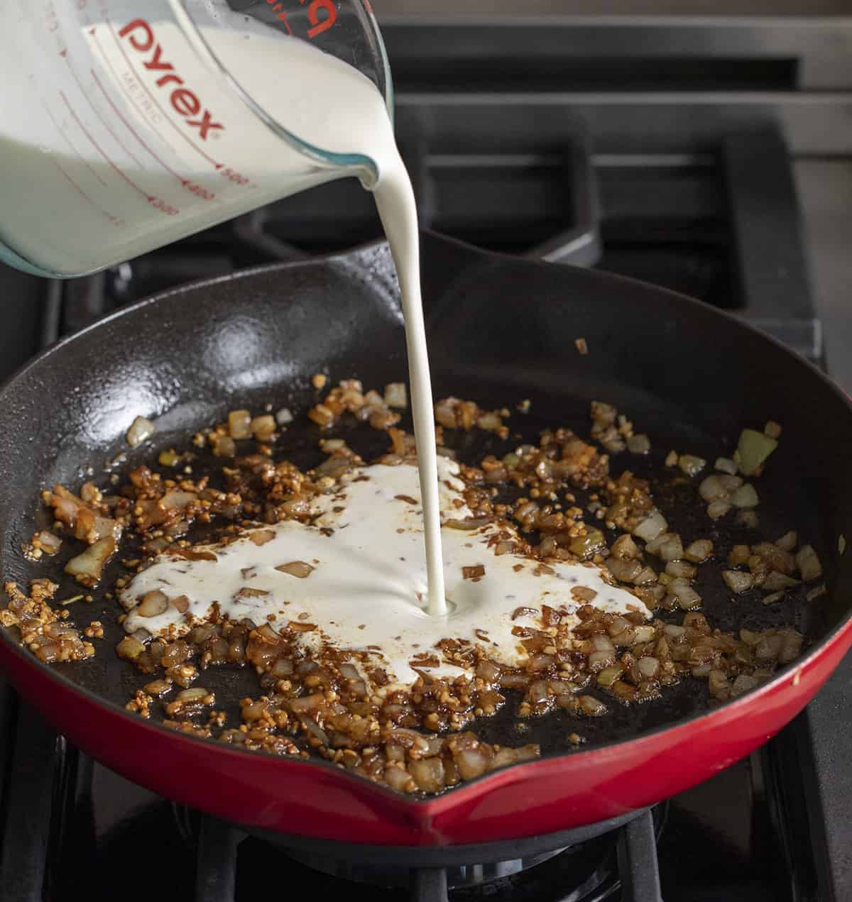Adding Heavy Cream to Onions in a Skillet