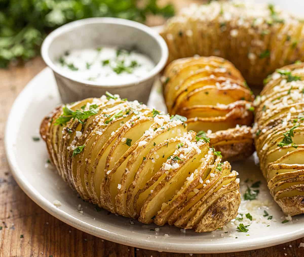 Hasselback Potatoes on a Plate with Sour Cream