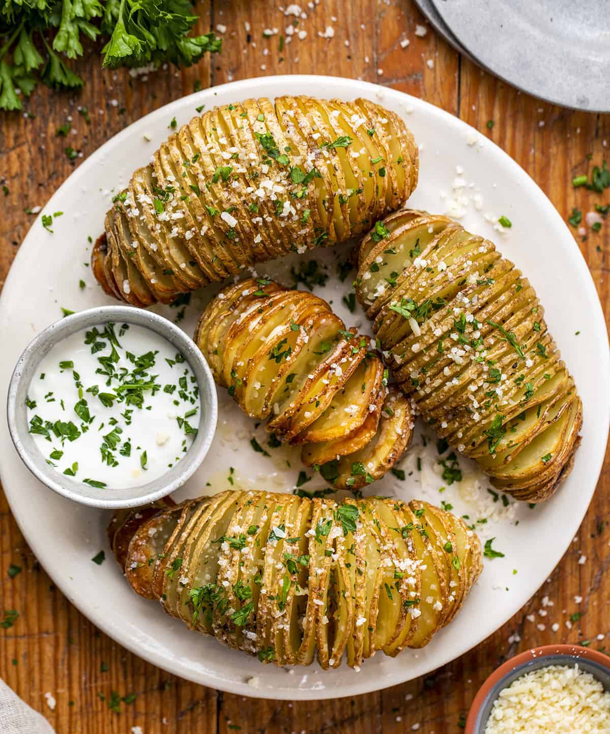 Overhead Plate of Hasselback Potatoes with Sour Cream
