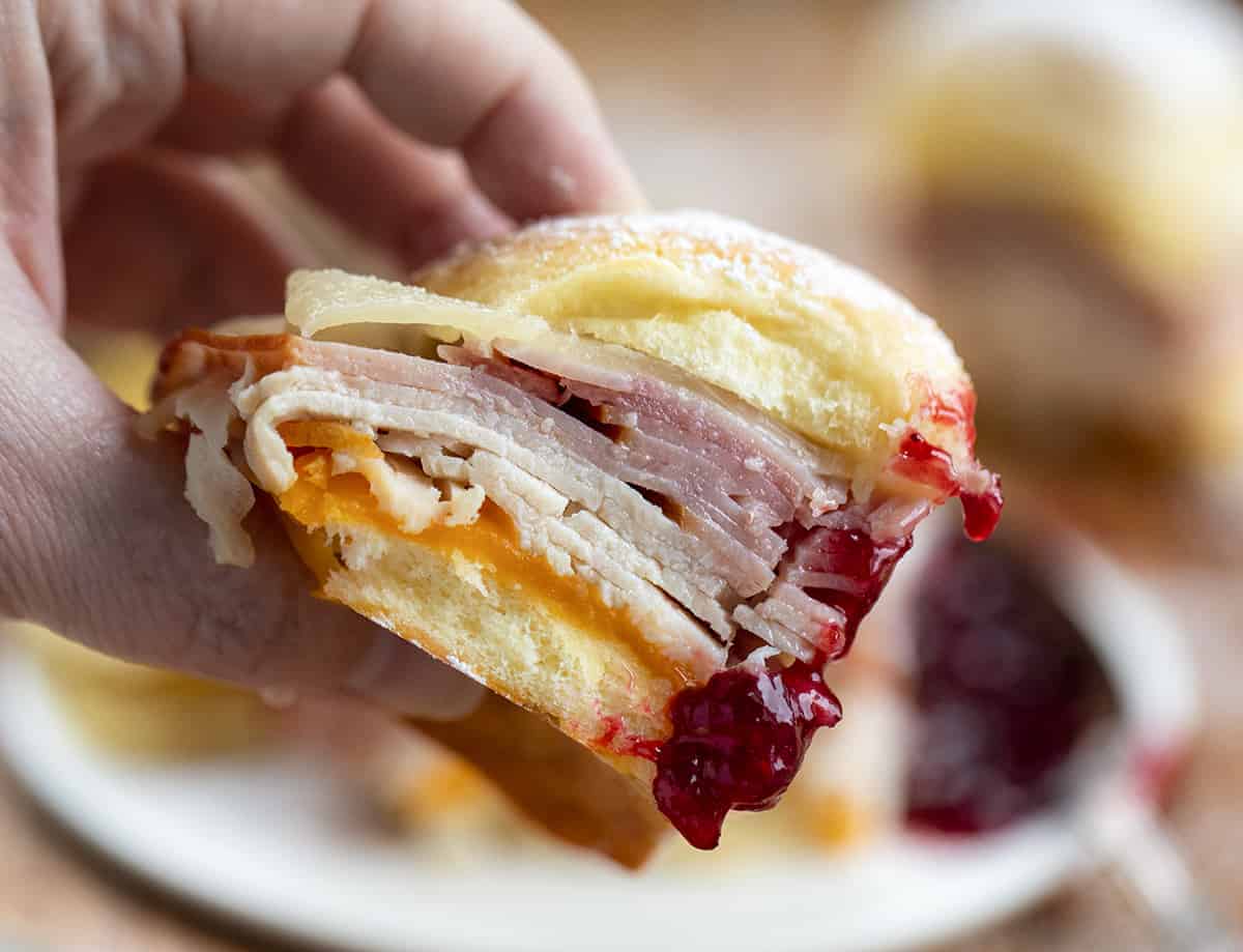 Hand Holding a Monte Cristo Slider with Raspberry Jam