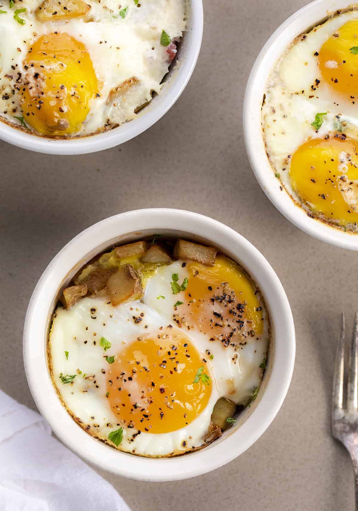 Overhead image of 3 cups of Baked Eggs- Eggs in a Cup - Shirred Eggs - Snug Eggs