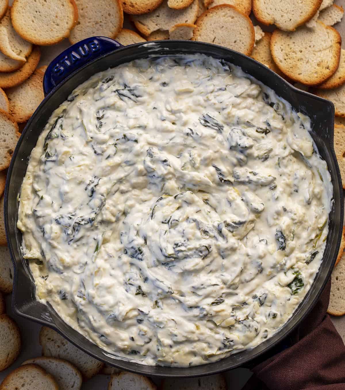 Overhead of Easy Spinach Dip with Baguettes around it