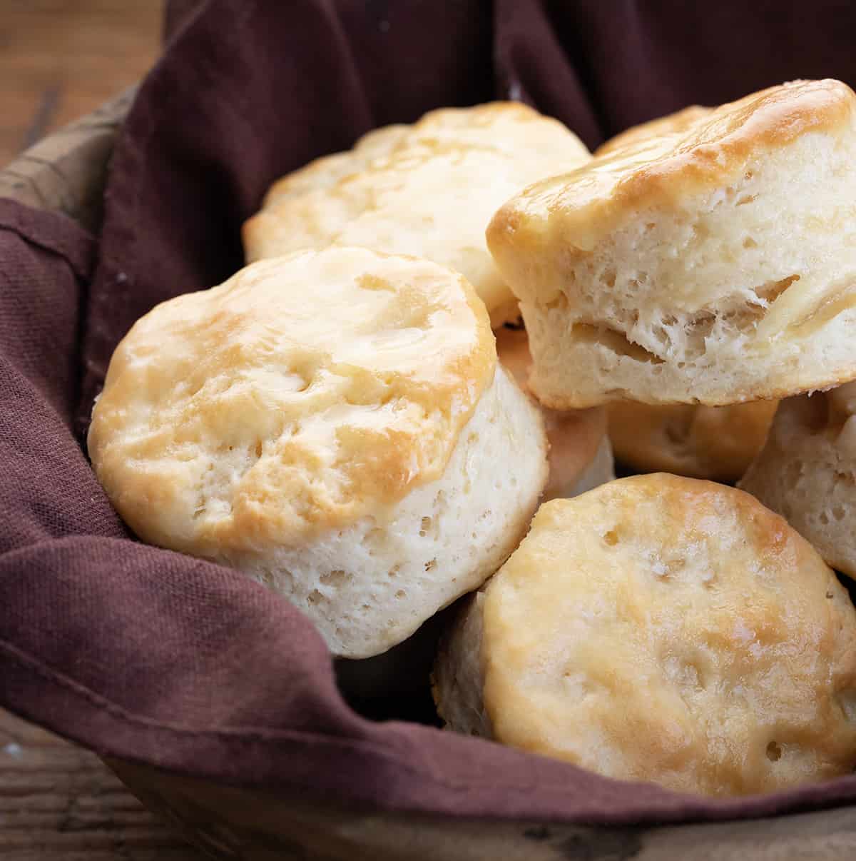 Close up of Buttermilk Biscuits in a bowl with brown towel.