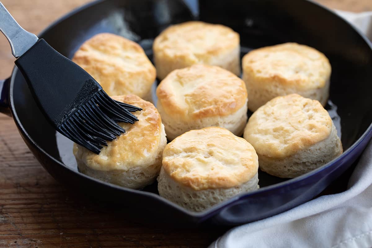 Brushing Butter over Buttermilk Biscuits.