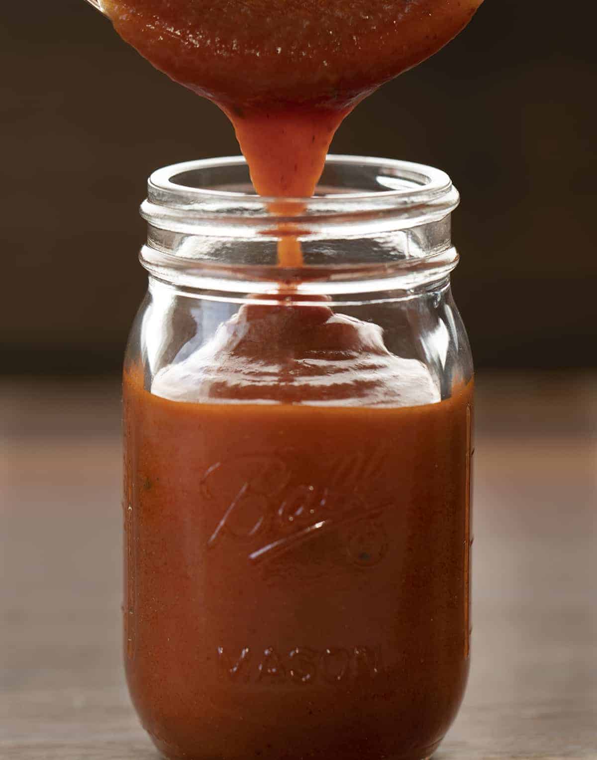 Pouring Easy Enchilada Sauce into a Jar