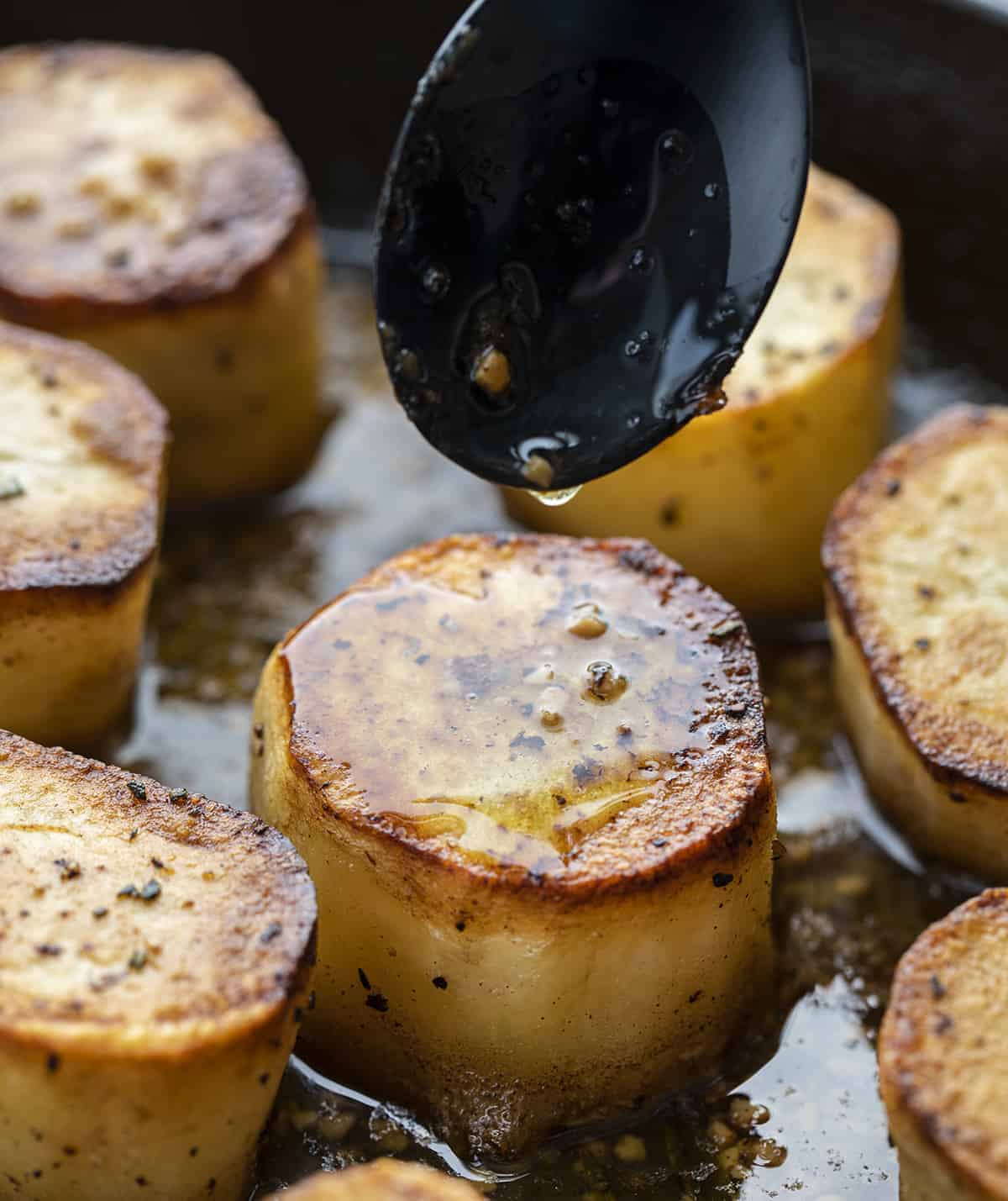 Spooning the Stock and Butter Sauce over Fondant Potatoes - Melting Potatoes