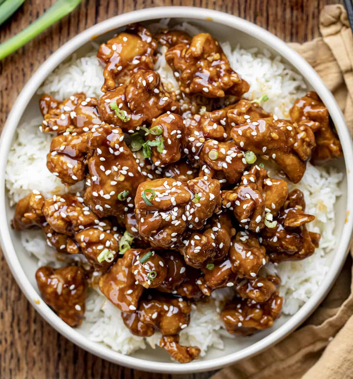 Bowl of General Tso Chicken Over Rice in a Bowl on A cutting Board