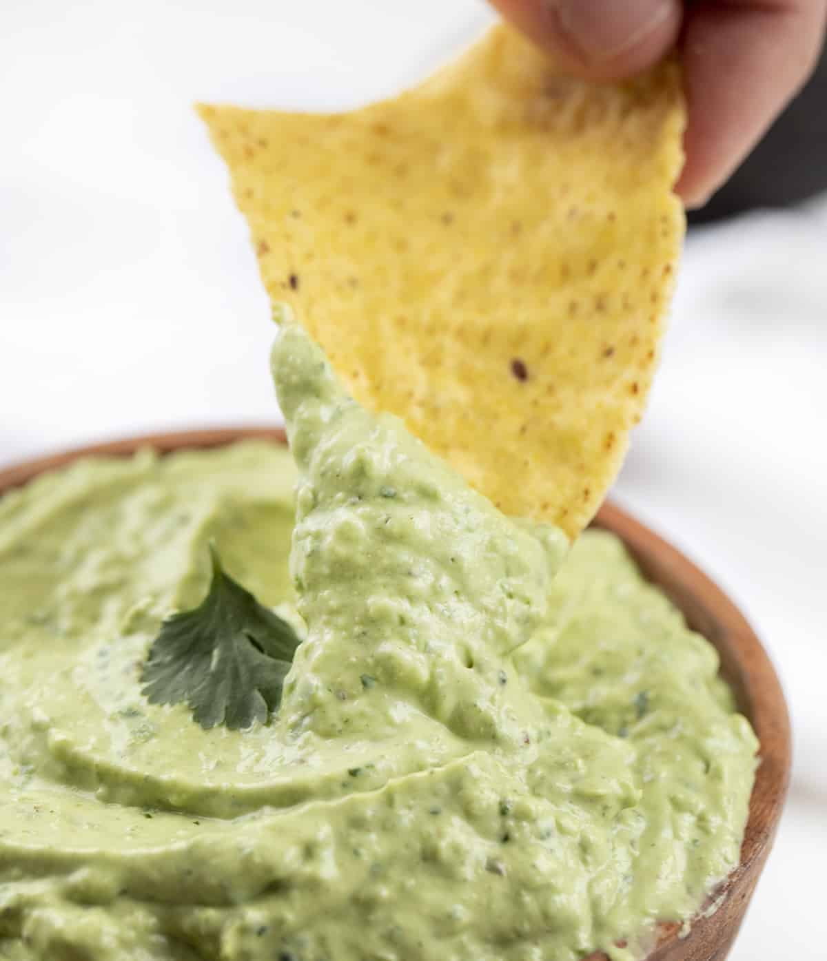 Chip Dipping Into Avocado Sauce