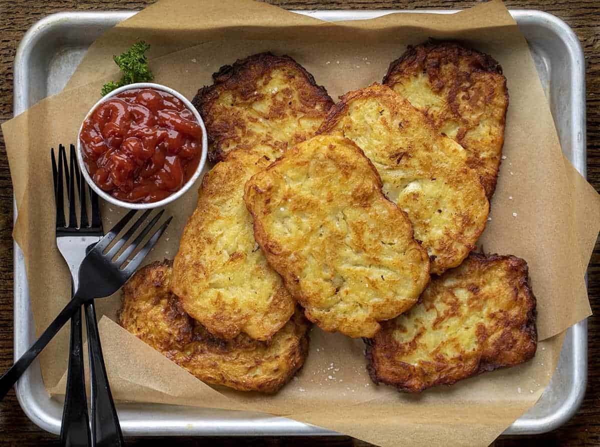 Tray filled with Homemade Hash Brown Patties from Overhead and with Forks.