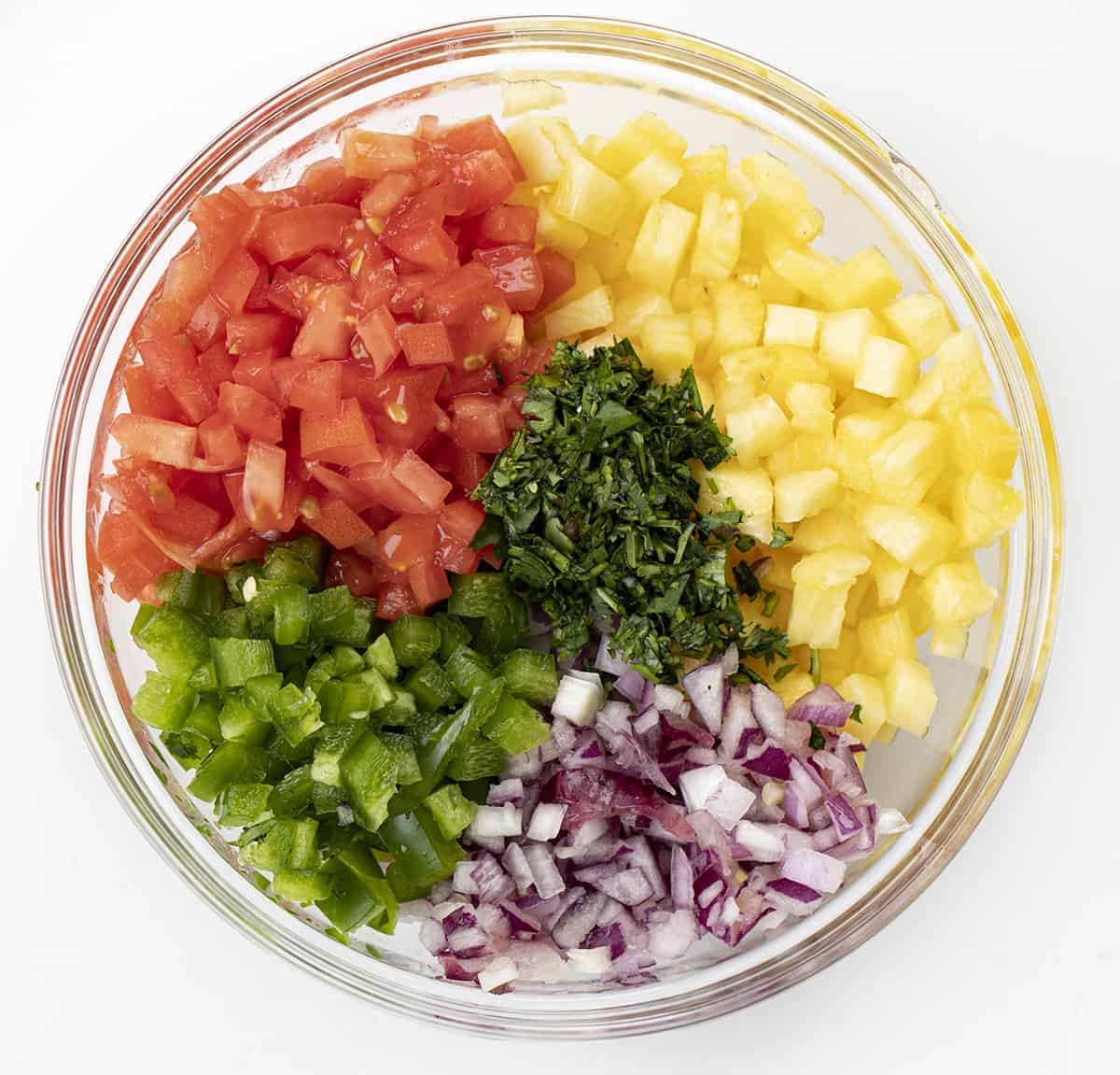 Raw Ingredients to Make Pineapple Salsa in a Bowl from Overhead