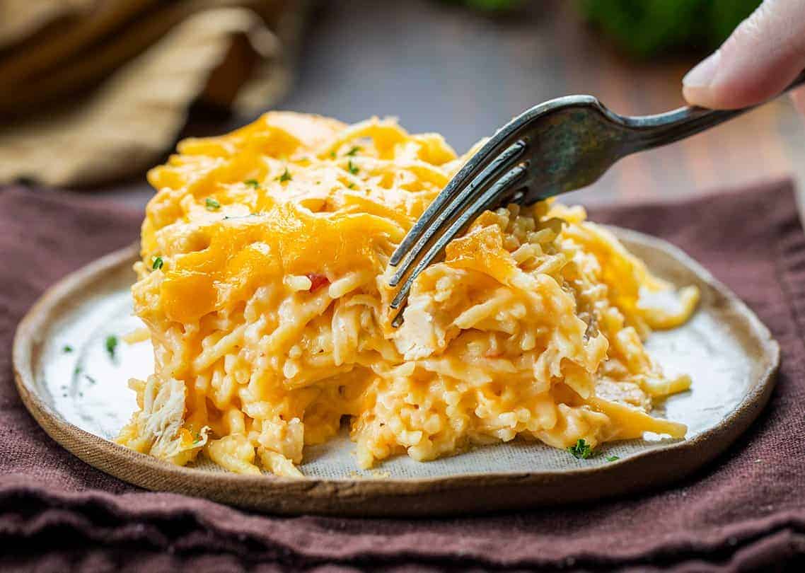 Dished up Chicken Spaghetti Mac and Cheese with a Fork Taking a Bite. 